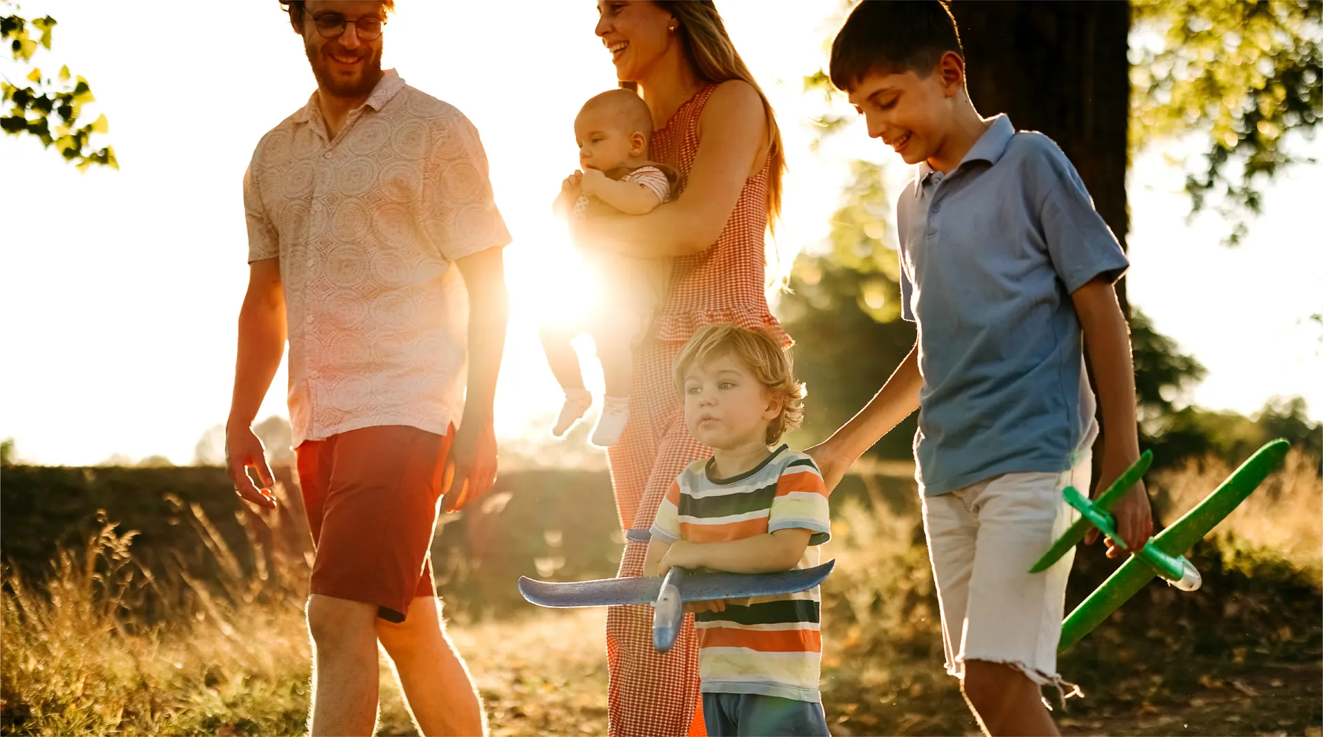 Lifestyle photograph labelled caledon-station in the Bolton Place marketing set — a family walking outdoors near Bolton, Caledon. Not a rendering of a GO station or the townhomes.